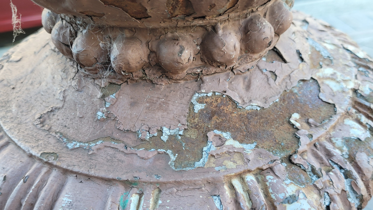 Layers of paint hide details on carved elements of historic buildings